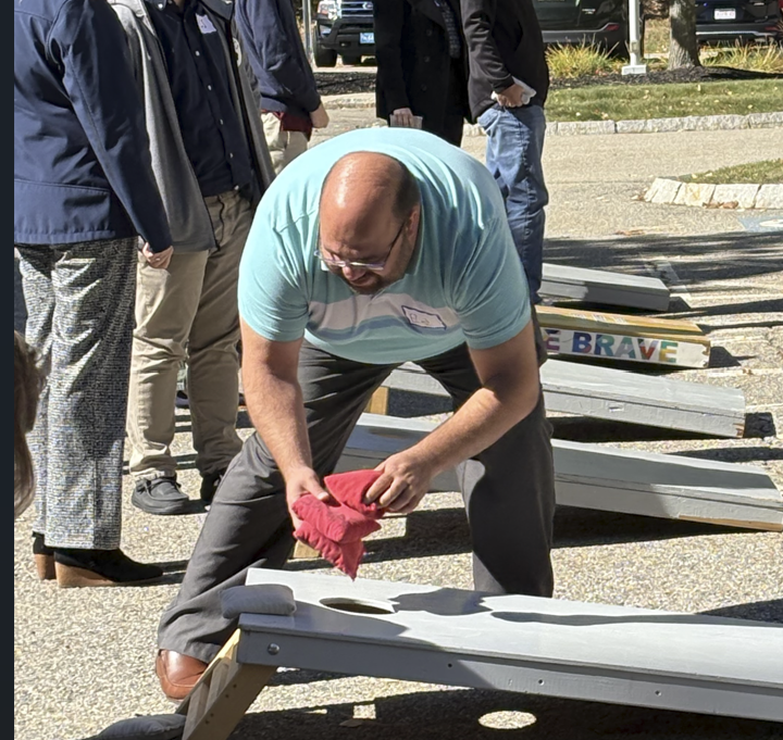Eduardo playing corn hole with Special Olympians Oct 2026